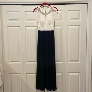 Sangria black and white long gown with crystal embellished neckline.